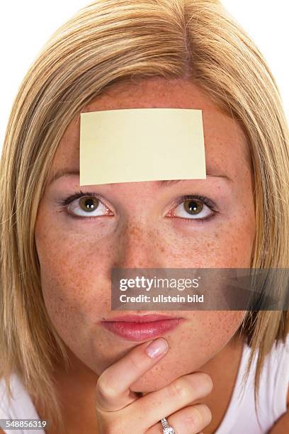 Woman with a notepad on her forehead -