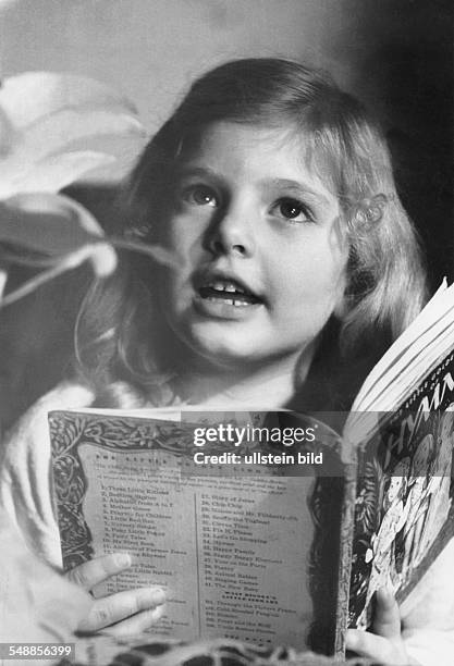 Germany - girl with English Christmas book - 1950s