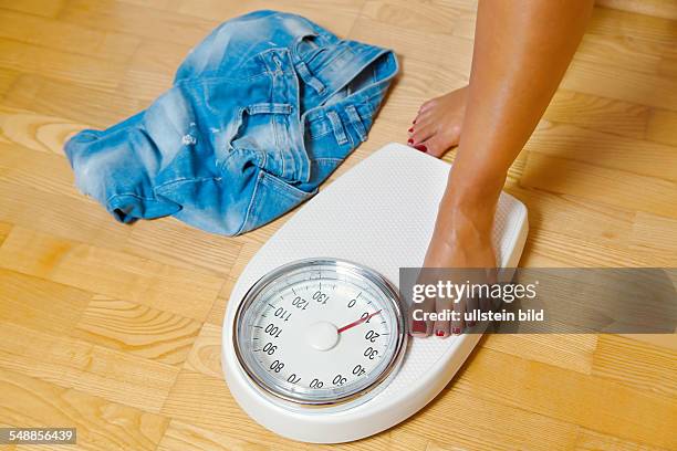 Symbolic photo diet, weight, woman on scales