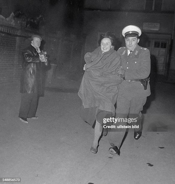 Germany Berlin Kreuzberg - Koepenicker Strasse: West Berlin policeman with a woman after her flight from East Berlin through the Spree river