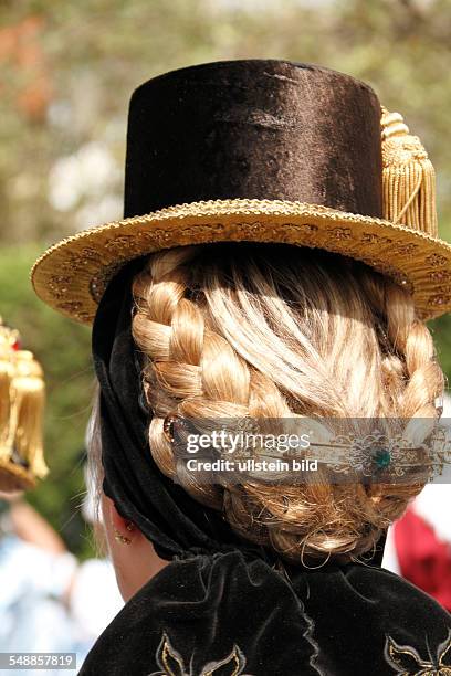 Germany Bavaria - Woman with Traditional bavarian hair style and hat, from behind