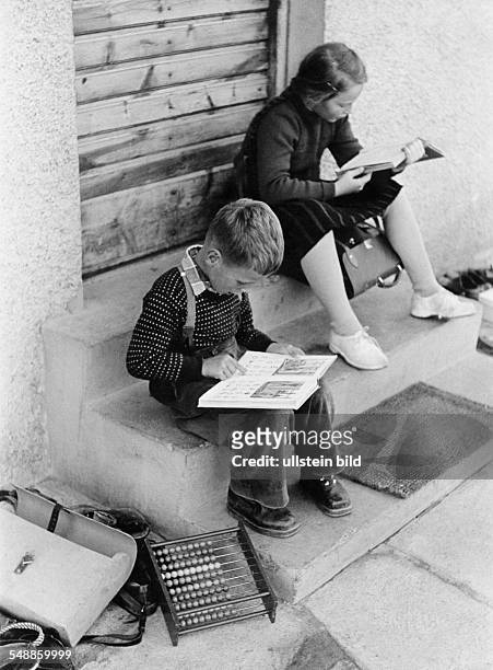 Germany Bavaria - pupils doing their homework on the stairs - 1950s