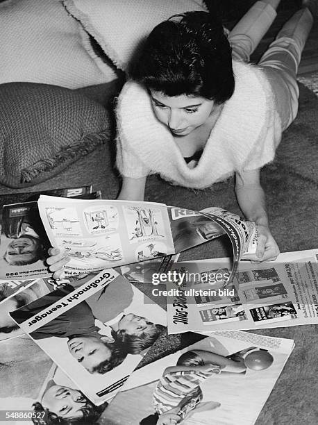 Young woman reading magazines - 1950s