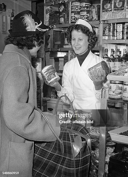 Shop assistant and customer in a grocery store - 1950s