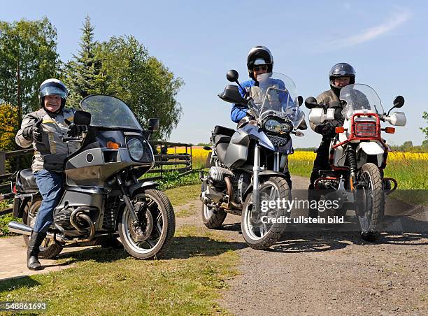 Three bikers with motorcycles -