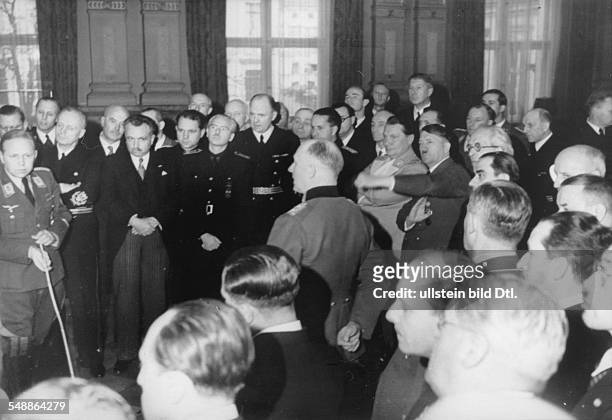 Reception at the Reich Chancellory in Berlin for the foreign delegations; Major Eckhard Christian is reporting back; - from Hitler to the left:...