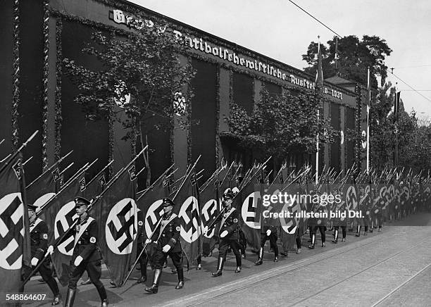 Nuremberg Rally 1937 Flag detachments of the SS marching past the Noris Hall where an 'Anti-Bolshevik Exhibition' took place - 1937 - Photographer:...