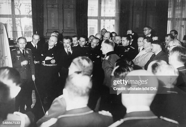 Reception at the Reich Chancellory in Berlin for the foreign delegations; Major Eckhard Christian is reporting back; - from Hitler to the left:...