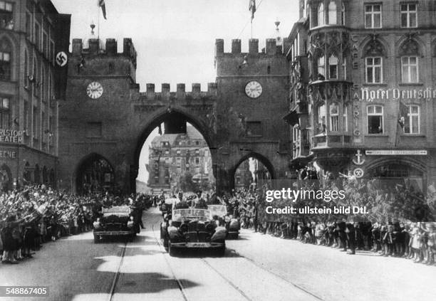 Adolf Hitler and Benito Mussolini in the car in front of the cheering crowd on the way through the Karlstor in Munich - - Photographer:...