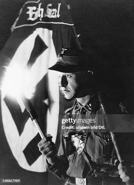 Member of the nationals socialist organization SA carrying a torch and a swastika banner - 1933 - Photographer: W.Fleischer - Vintage property of...