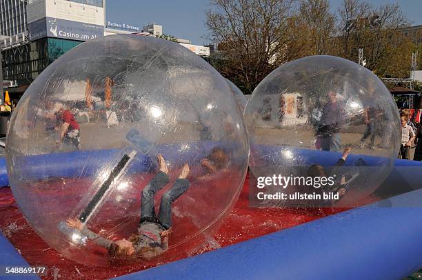 Germany Berlin Mitte - children are playing Fun-Ball at Alexanderplatz -