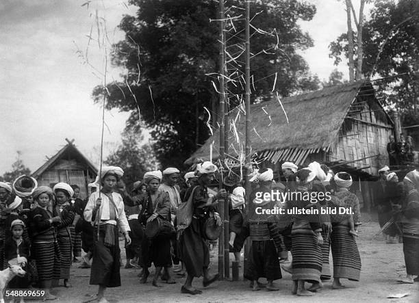 China: The New Year - celebrations: People of the tribu Lahu dancing around the Christmas tree - ca. 1942 - Photographer: Hugo Adolf Bernatzik...