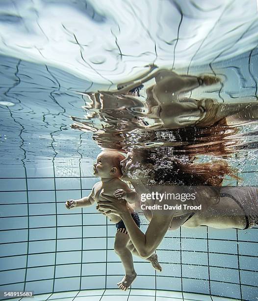 child learning to swim. - toddler learning stock pictures, royalty-free photos & images