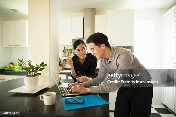 young couple working at home - malay couple stock pictures, royalty-free photos & images