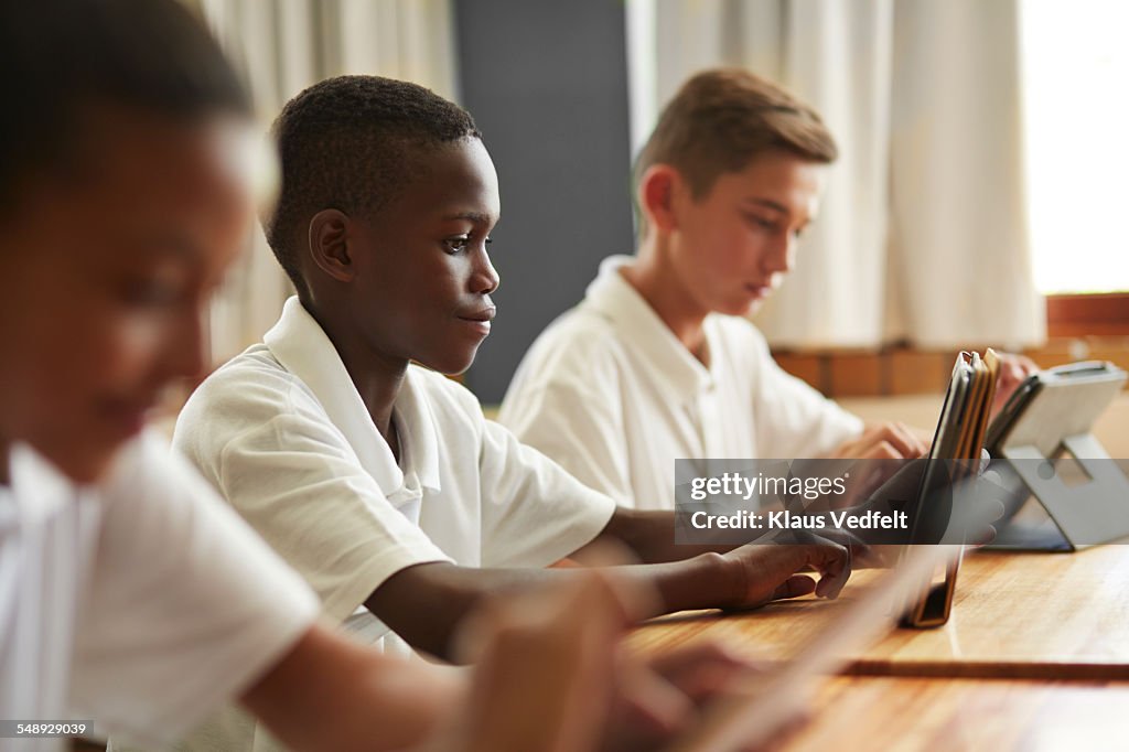 Students working on tablets in classroom