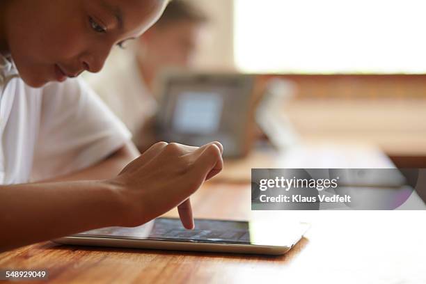 close-up of schoolgirl scrolling on tablet - e learning africa stock pictures, royalty-free photos & images