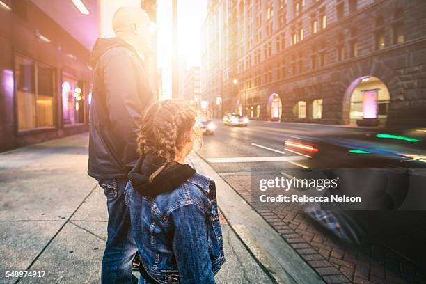 father and daughter about to cross street - chicago dusk stock pictures, royalty-free photos & images