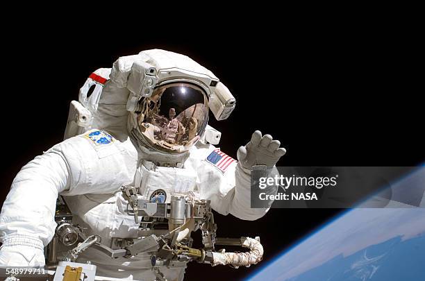 American astronaut Joseph Tanner waves to the camera during a space walk as part of the STS-115 mission to the International Space Station, September...