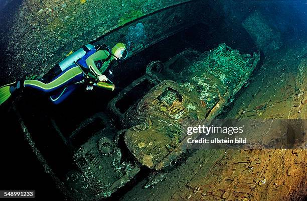 Scuba diver diving in the Umbria shipwreck, Military cars, Sudan, Africa, Red Sea, Wingate Reef