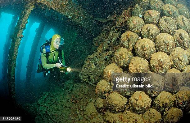 Scuba diver diving in the Umbria shipwreck, Bombs, Sudan, Africa, Red Sea, Wingate Reef
