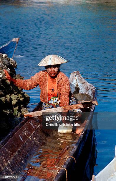 Indonesian Woman in fishing boat, Indonesia, Sulawesi, Celebes, Fishing village Lamanggau