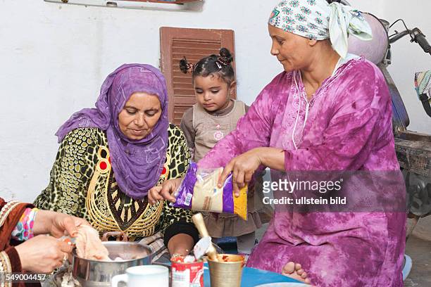 Tunisia: Sidi Mtir, women in traditional clothing preparing the meal for Eid al-Adha