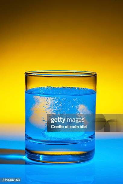 Eine Brausetablette löst sich in einem Glas Wasser auf