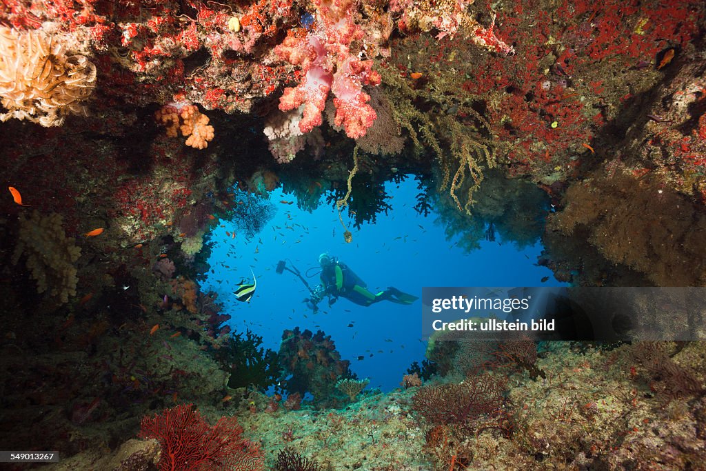 Scuba Diver behind Swimthrough, Namena Marine Reserve, Fiji