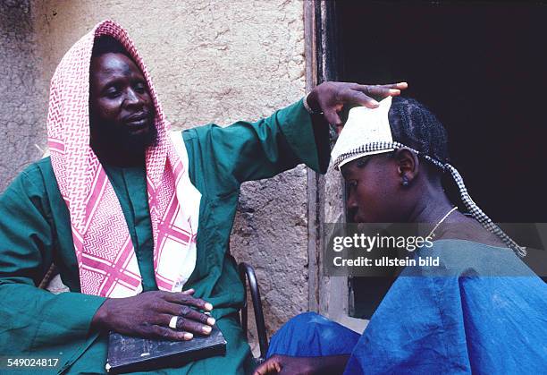 Marabout puts Gringri on the head of a circumcised girl. -