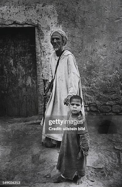 Morocco, Fes: A little boy is leading a blind man