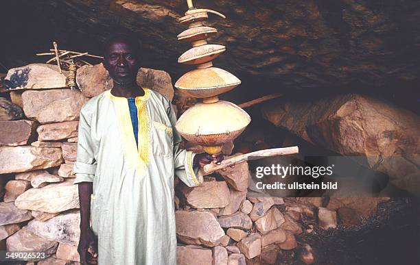 The circumcision master of Songo with a giant rattle. -