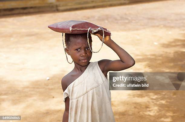 Benin, Mono district, Adomé: A small girl on her way to school.