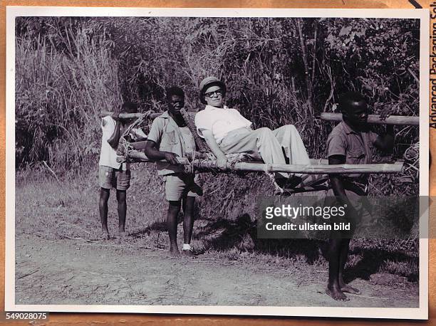 Congo, Africa, Belgian Congo. Belgian administrator being carried through the bush. Historical photo 1950.