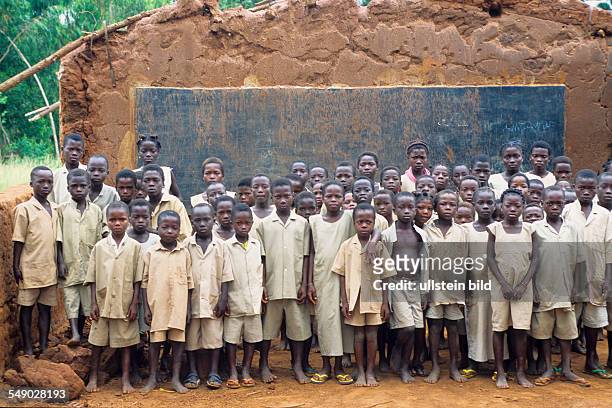 Dotou, Benin, Africa: School children in front of their broken down school.
