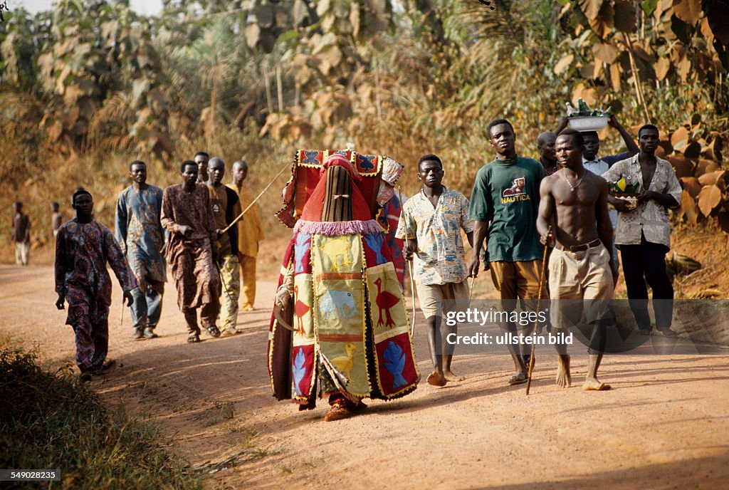 BEN, Benin: A EGUNGUN walking from village to village collecting money for the upcoming ceremony. -