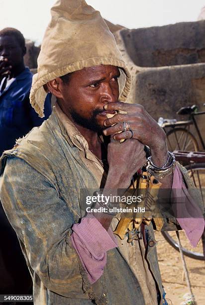 Ghana: Musician with his wooden flute. -