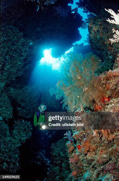 Scuba diver in underwater grotto, Egypt, Zabargad, Zabarghad, Red Sea