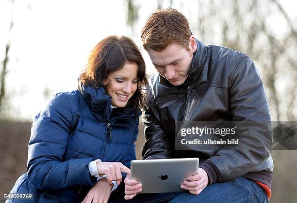 A young couple with an Apple iPad