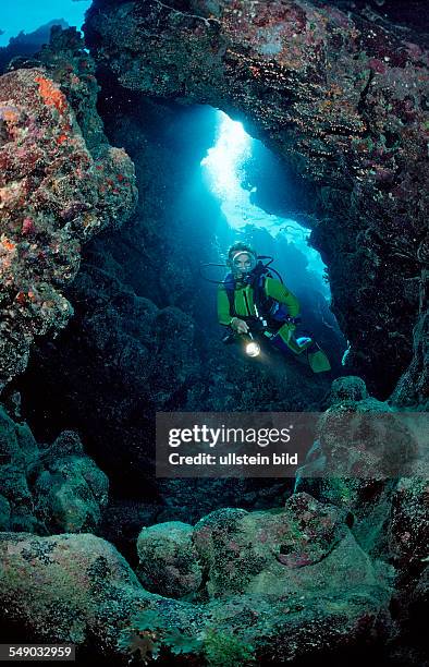 Scuba diver in underwater grotto, Egypt, Zabargad, Zabarghad, Red Sea