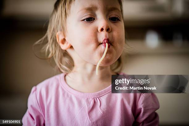 child sucking spaghetti - slovakia food stock pictures, royalty-free photos & images