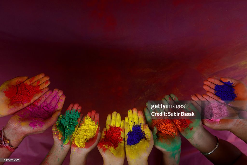 Color powder on hands during Holi festival, India