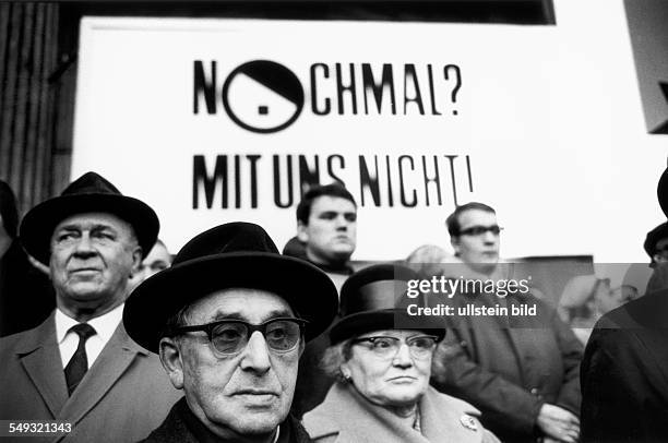 Germany, Hannover, November 1967, elderly people protesting outside the building against the NPD party congress with a poster saying "Not again with...