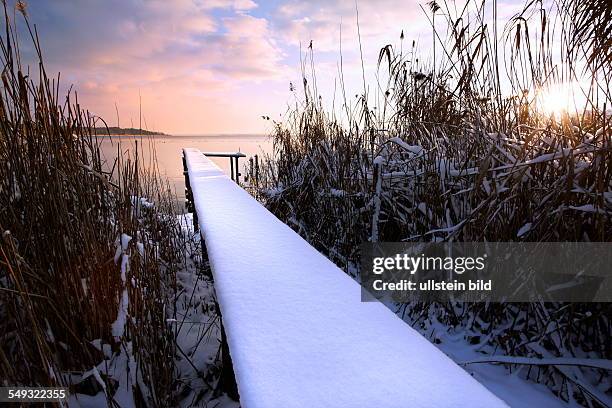 Virgin winter snow on old wooden pier, Chiemsee, Chiemgau, Upper Bavaria, Germany