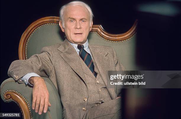 German cartoonist and actor Vicco von Bülow, Loriot, on his sofa in front of TV camera in the studio of Radio Bremen