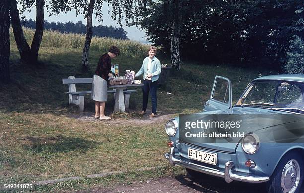 Travellers from Berlin have a picnic at the roadside - around 1964