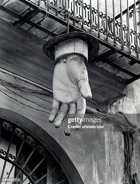 Spain, Barcelona, oversized hand made of plastic hanging on front of old building for advertising.