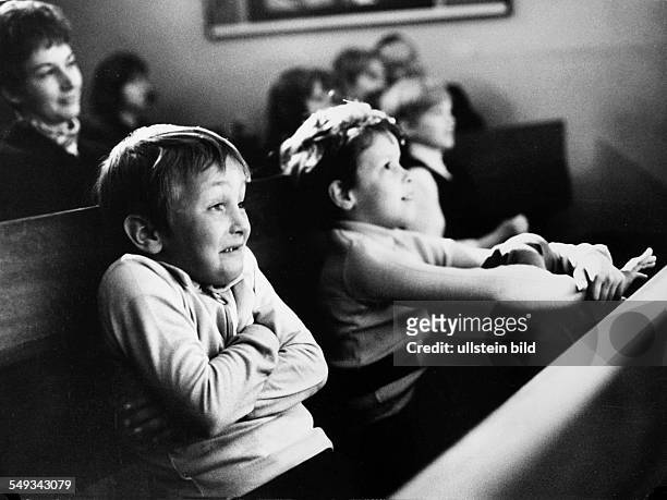 Germany, children watching a play in the childrens theater in Berlin, concentrated spectators