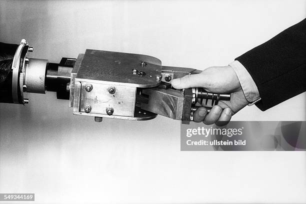 Man shaking hand with robot, symbol