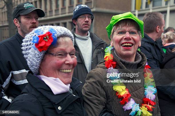 Rheinish Carnival in Krefeld, North Rhine-Westphalia, two women watching a parade at "Old Women Day" or "The Women's Day"