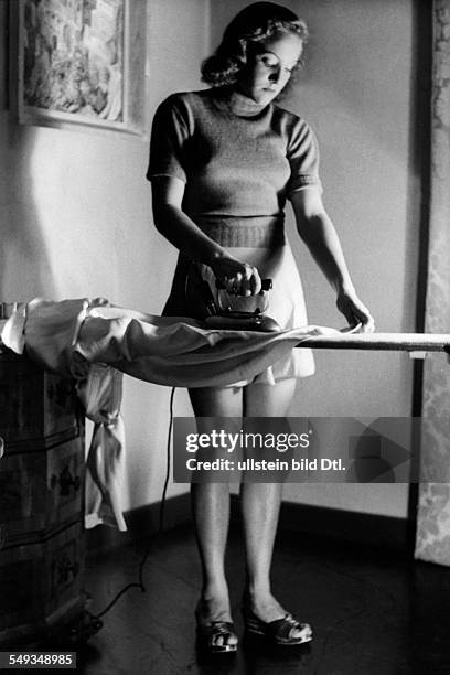 Energy saving tips for housewifes during the Second World War; a woman ironing - ca. 1942 - Photographer: Wolfgang Weber - Published by: 'Berliner...